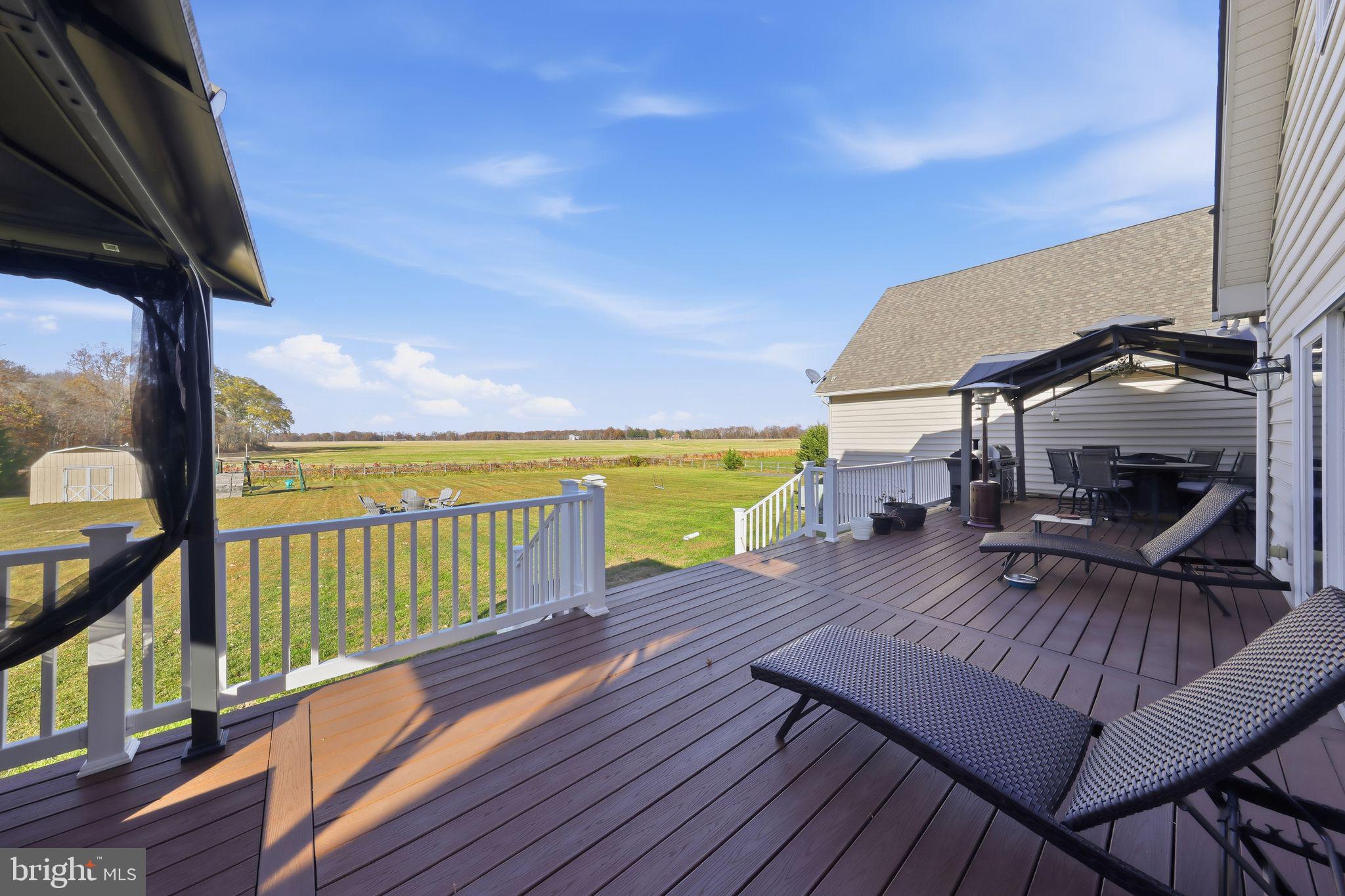 121 Little Eagle Road Centreville, MD 21617 - Photo 50 of 64 a view of a balcony with wooden floor and outdoor seating
