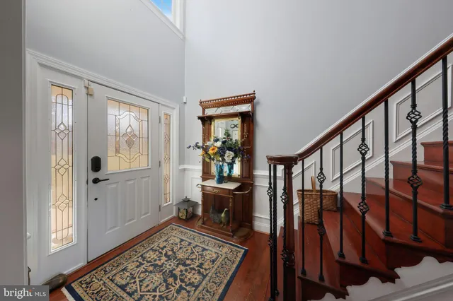 a view of a hallway with wooden floor and entryway