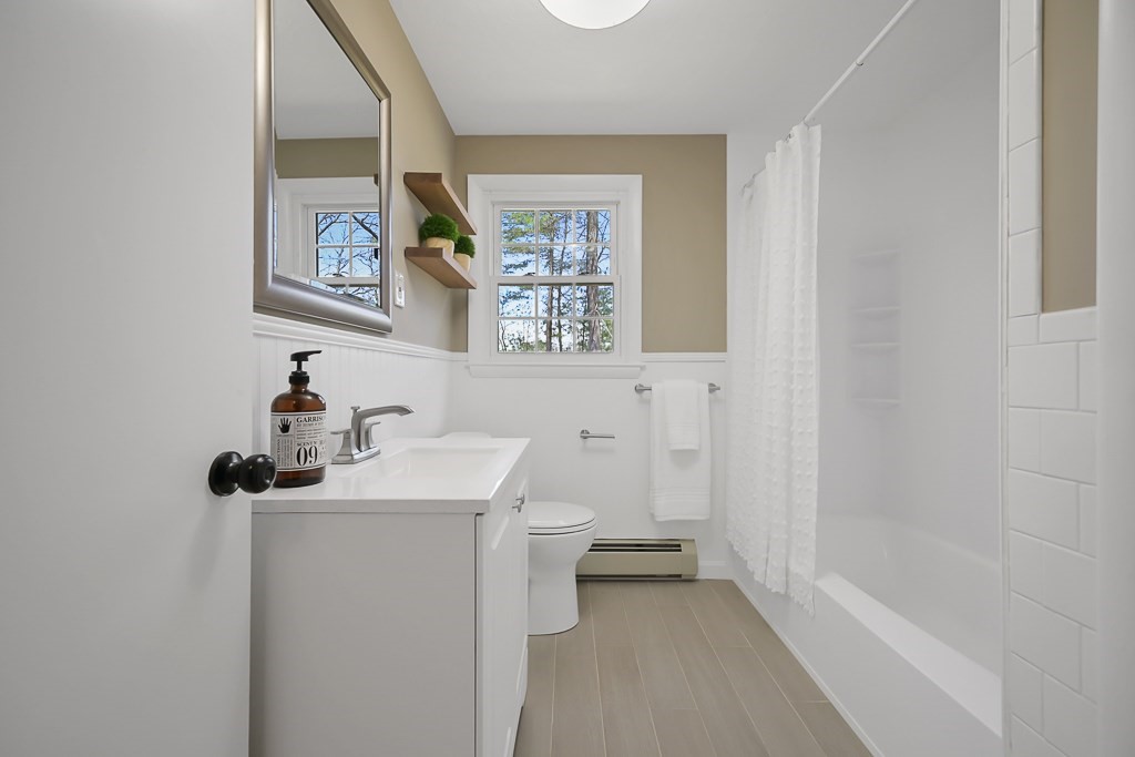 28 Hadley Road Sudbury, MA 01776 - Photo 21 of 30 a bathroom with a sink a toilet and a mirror