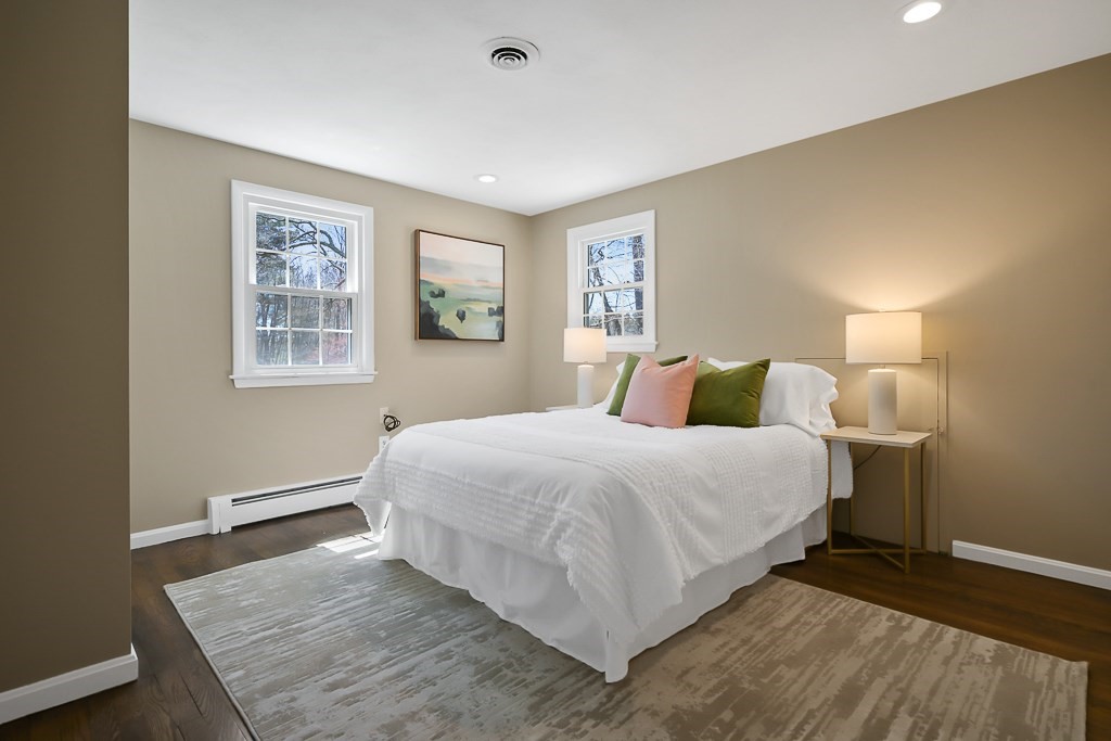 28 Hadley Road Sudbury, MA 01776 - Photo 22 of 30 a bedroom with a bed and wooden floor