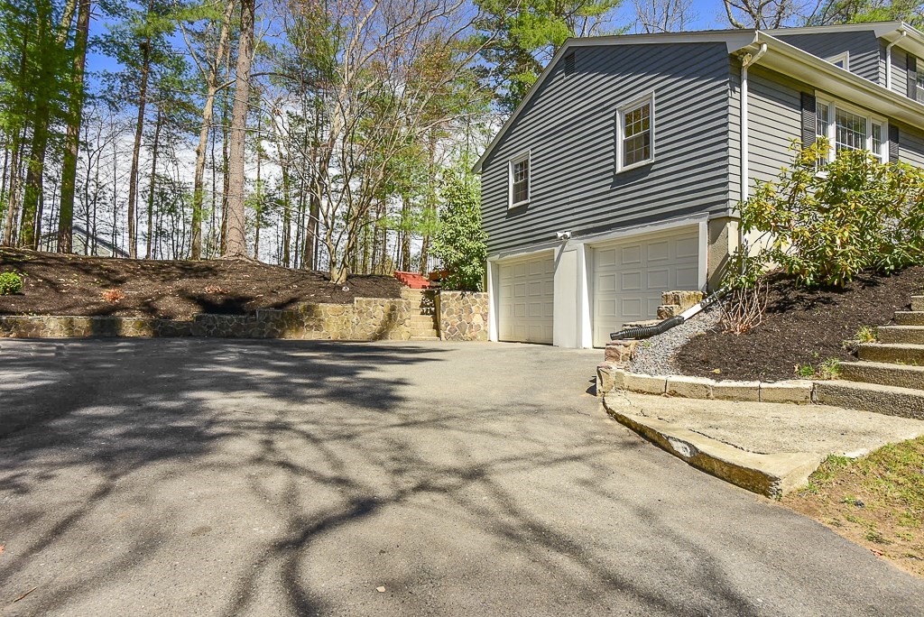 28 Hadley Road Sudbury, MA 01776 - Photo 29 of 30 a view of a white house with a small yard and large tree