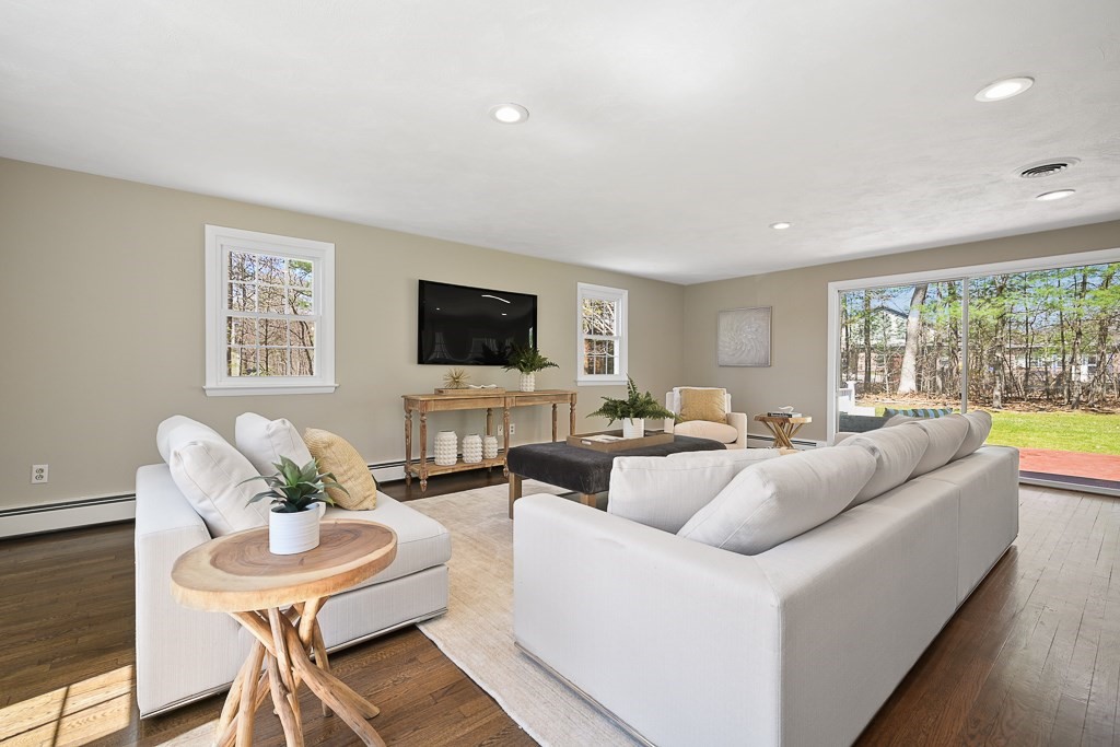 28 Hadley Road Sudbury, MA 01776 - Photo 5 of 30 a living room with furniture a flat screen tv and a large window