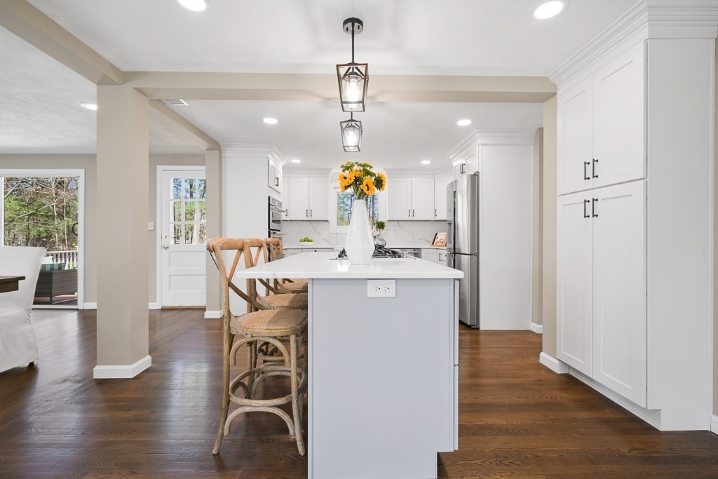 28 Hadley Road Sudbury, MA 01776 - Photo 6 of 30 a very nice looking dining room with kitchen island a wooden floor and a chandelier