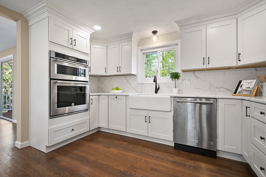 28 Hadley Road Sudbury, MA 01776 - Photo 8 of 30 a kitchen with cabinets stainless steel appliances and wooden floor
