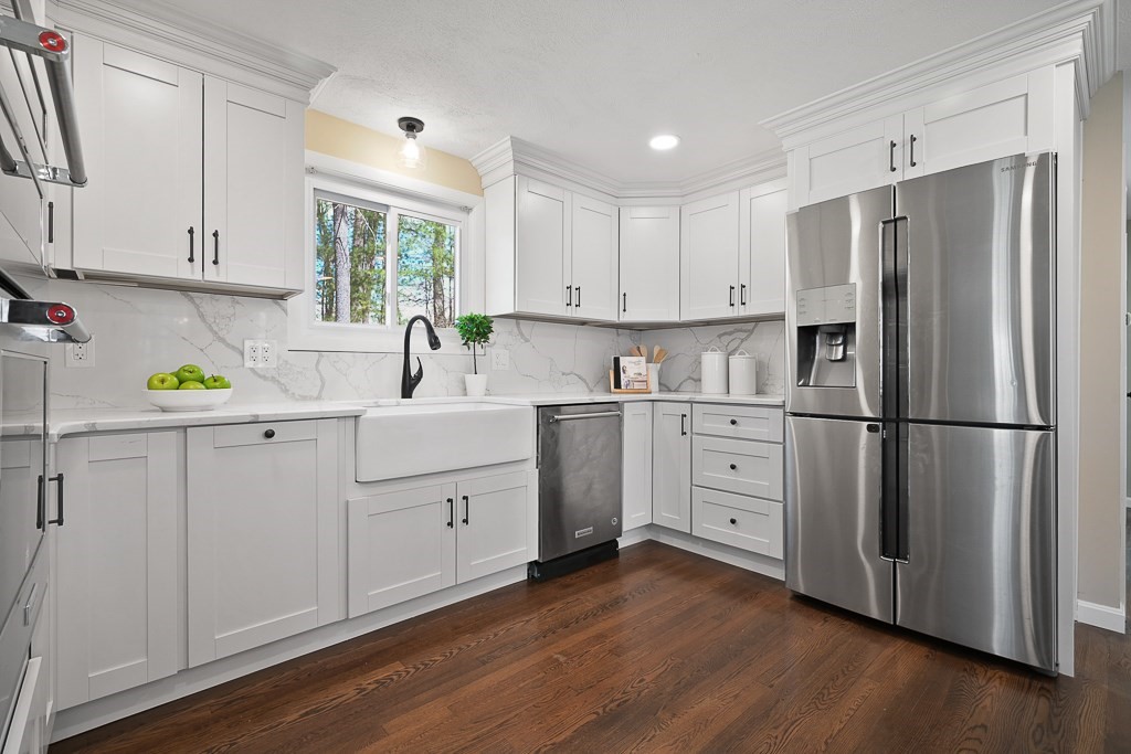 28 Hadley Road Sudbury, MA 01776 - Photo 9 of 30 a kitchen with white cabinets white appliances and wooden floors