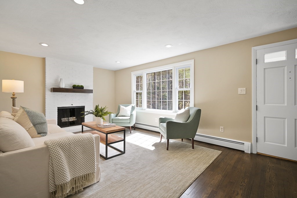 28 Hadley Road Sudbury, MA 01776 - Photo 10 of 30 a living room with furniture and a fireplace