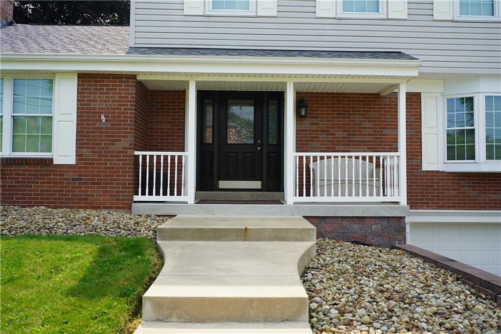 8372 Post Road Allison Park, PA 15101 - Photo 8 of 9 a front view of a house with a garden