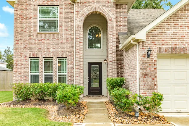 a view of a brick house with a large windows