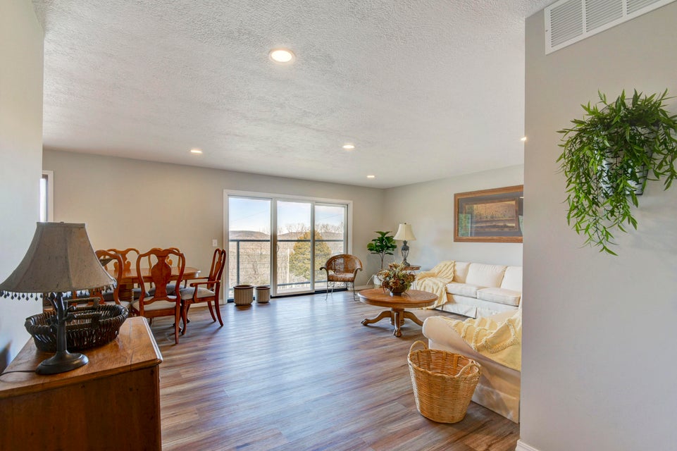 Spacious living area featuring wood-finish flooring and recessed lighting