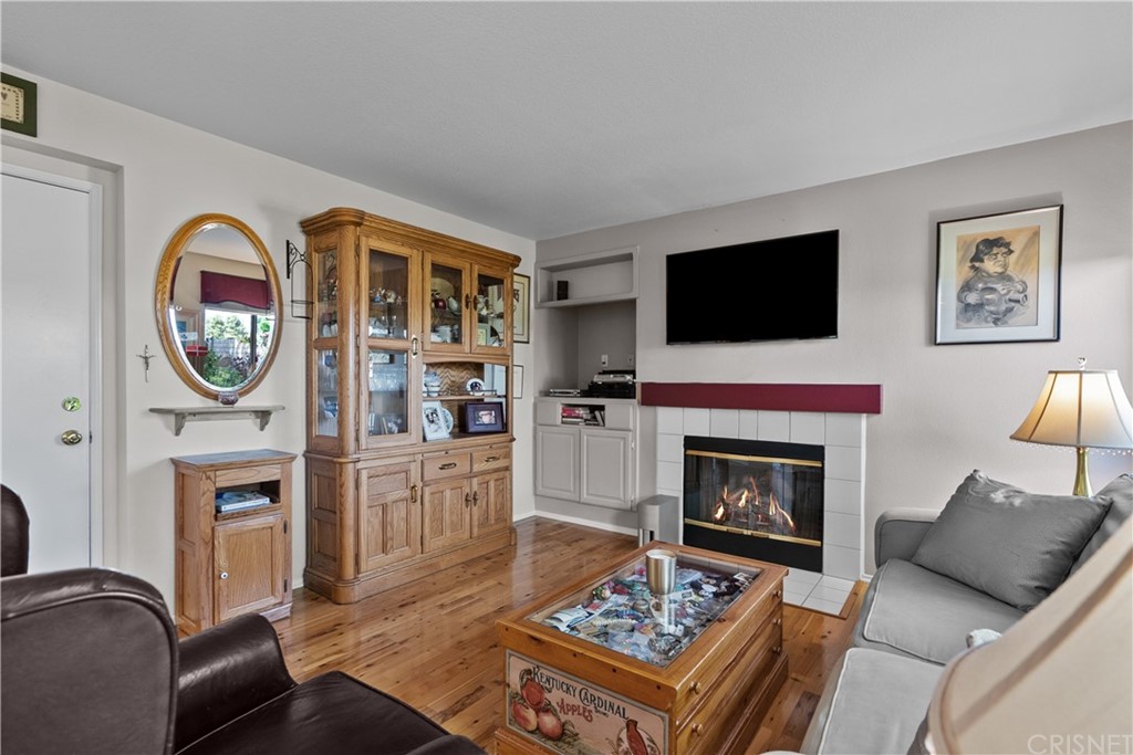27710 Kristin Lane Saugus, CA 91350 - Photo 11 of 32 a living room with furniture a fireplace and a flat screen tv