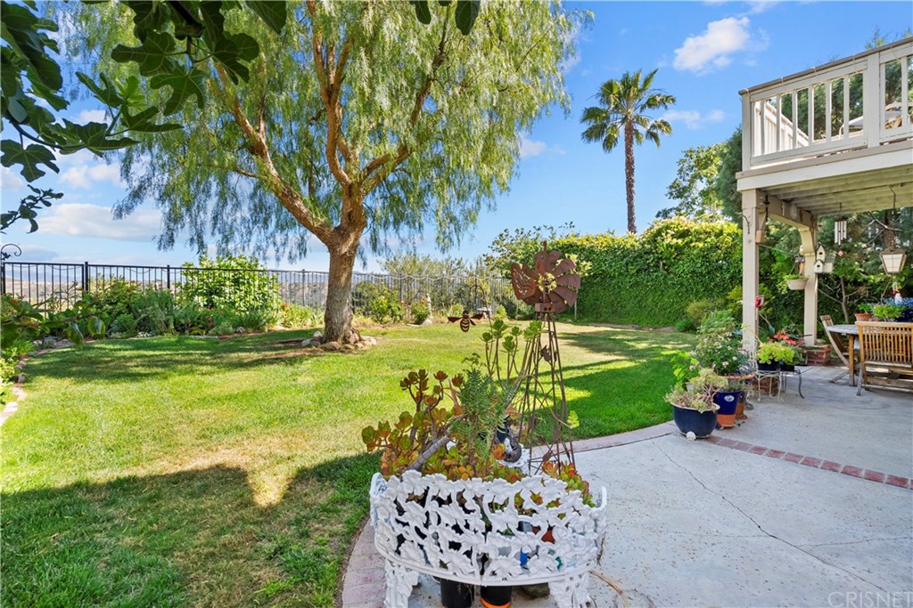 27710 Kristin Lane Saugus, CA 91350 - Photo 19 of 32 a view of a patio with a table and chairs and potted plants