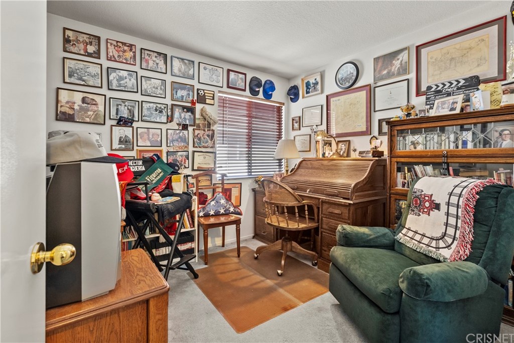 27710 Kristin Lane Saugus, CA 91350 - Photo 24 of 32 a living room with furniture and a book shelf