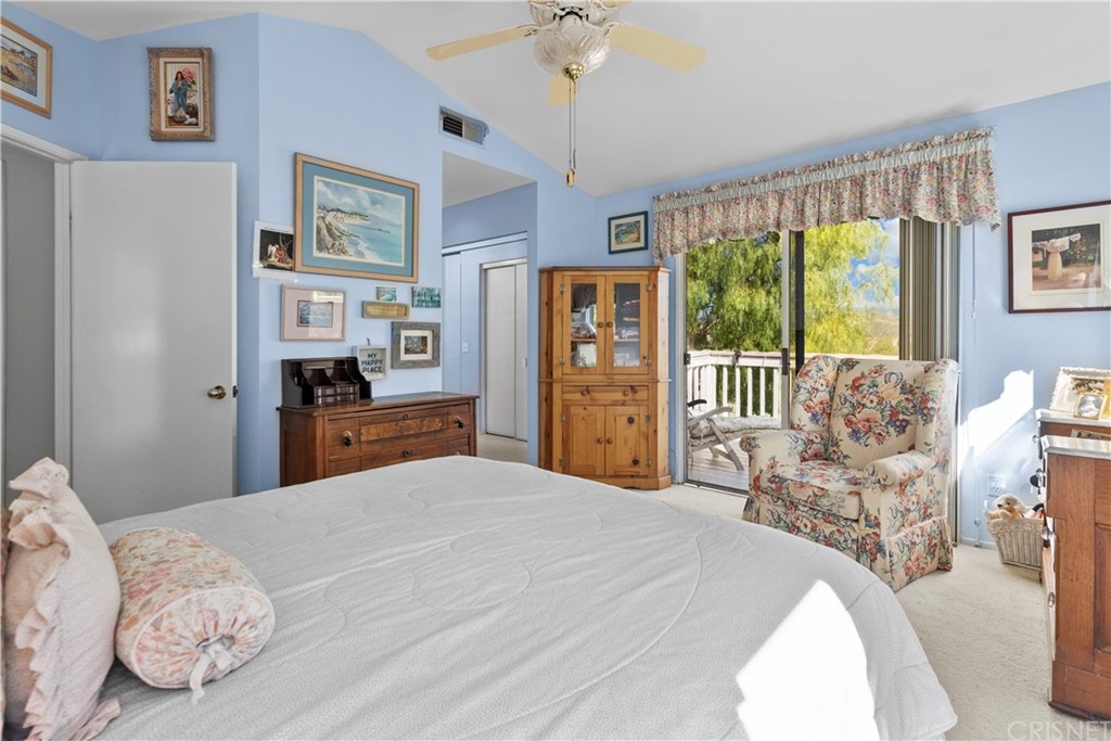 27710 Kristin Lane Saugus, CA 91350 - Photo 26 of 32 a bedroom with a bed and a chandelier