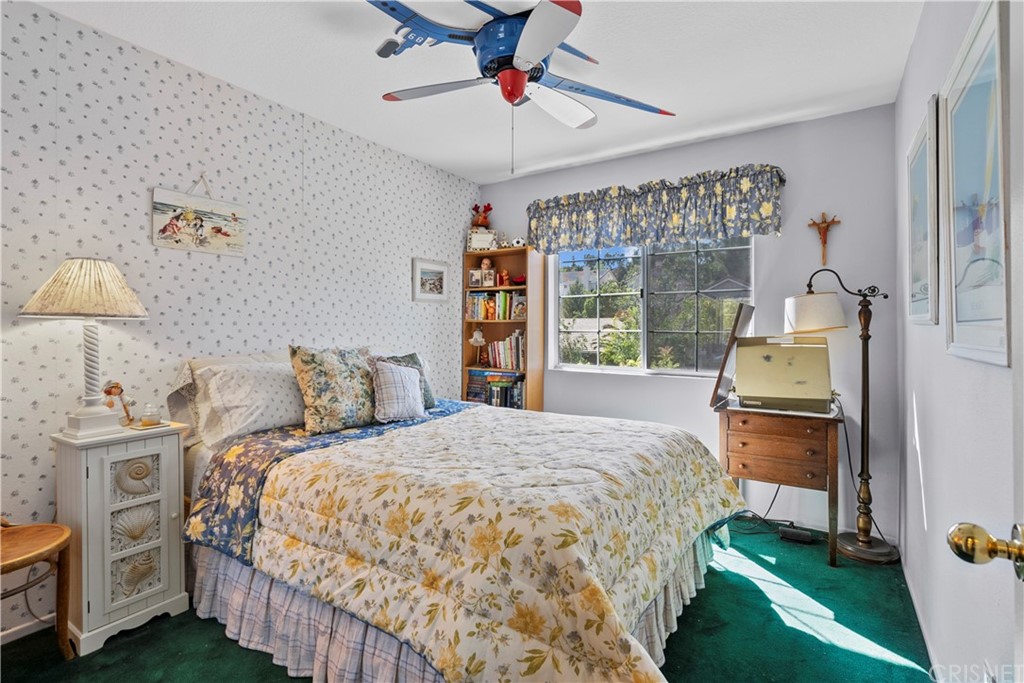 27710 Kristin Lane Saugus, CA 91350 - Photo 29 of 32 a bedroom with a bed and a chandelier