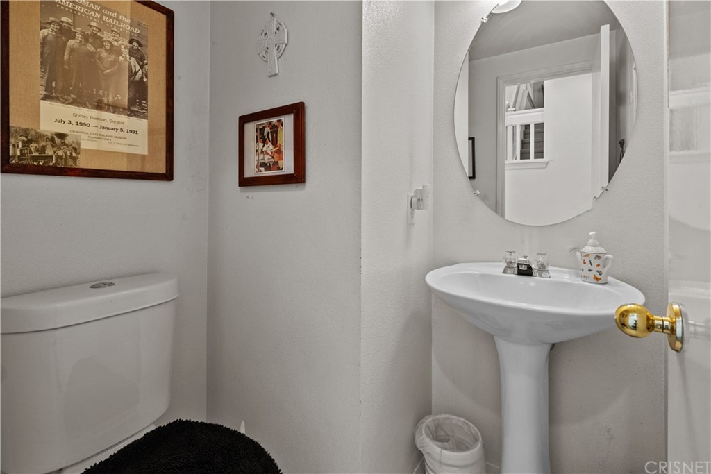 27710 Kristin Lane Saugus, CA 91350 - Photo 9 of 32 a bathroom with a toilet sink and mirror