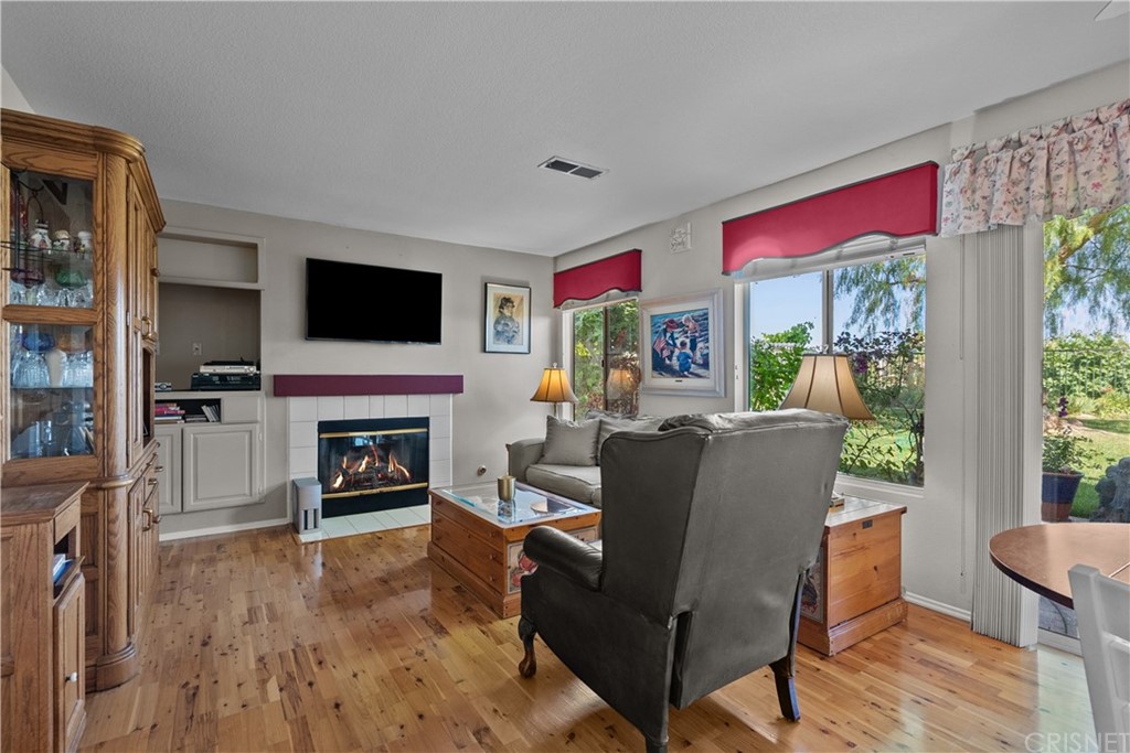 27710 Kristin Lane Saugus, CA 91350 - Photo 10 of 32 a living room with furniture a flat screen tv and a fireplace