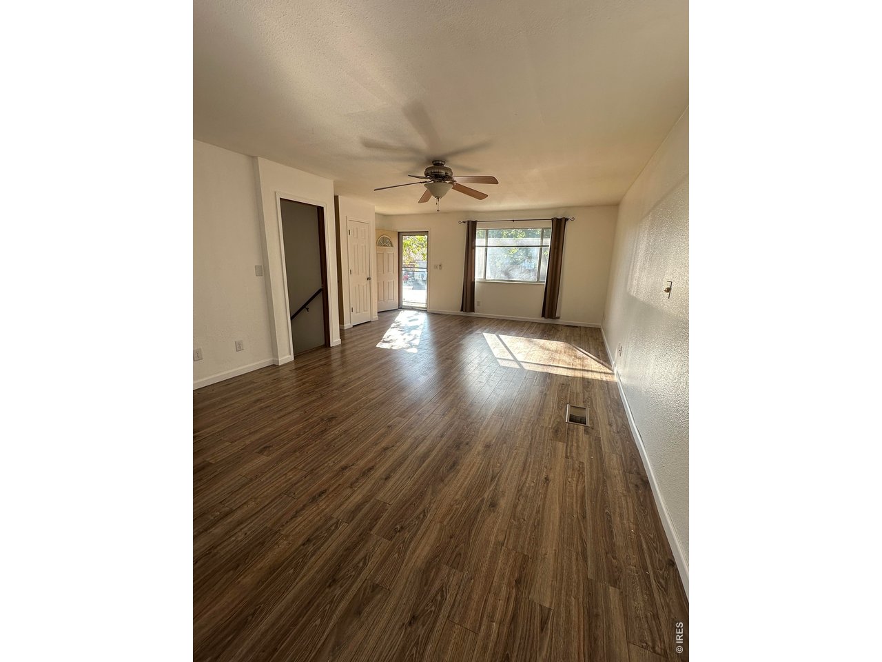 268 Fifth Street Firestone, CO 80520 - Photo 9 of 25 a view of a hallway with wooden floor