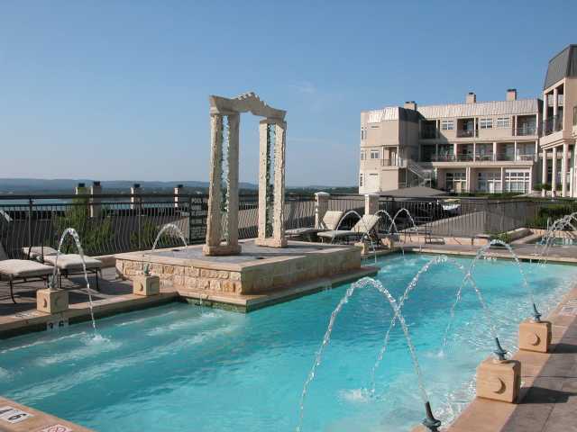 a view of a swimming pool with lawn chairs