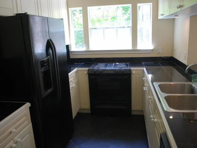 a kitchen with a refrigerator and a sink