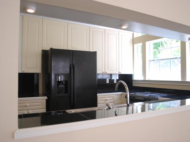 2918 Ranch Road 620, Unit 172 Austin, TX 78734 - Photo 4 of 18 a kitchen with a refrigerator and a sink