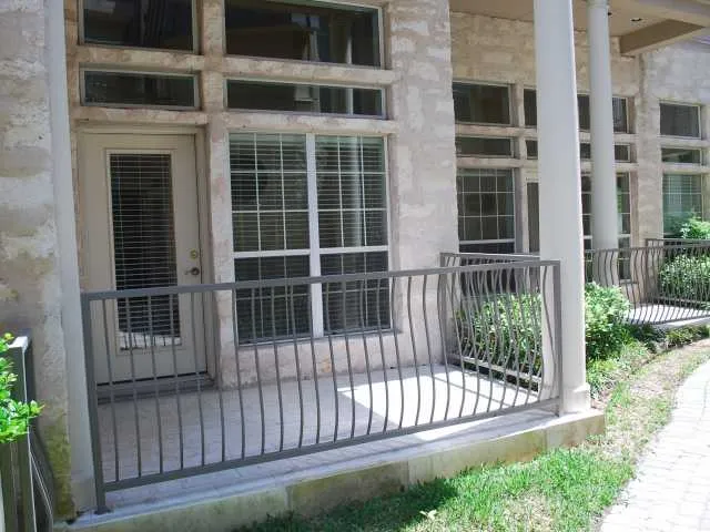 a view of a house with a large window and wooden fence