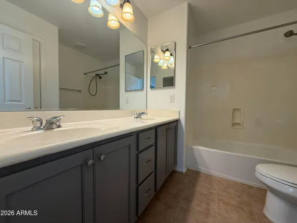 a bathroom with a double vanity sink mirror and toilet