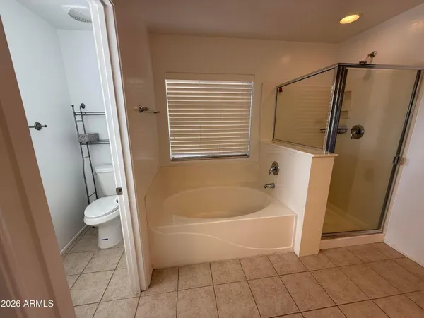 a white bath tub sitting next to a white toilet