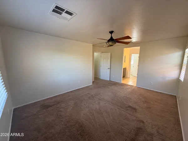 a view of a livingroom with a ceiling fan and window