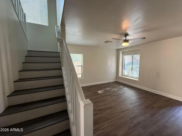 a view of entryway and hall with wooden floor