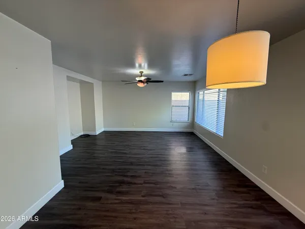 a view of a room with wooden floor and a window