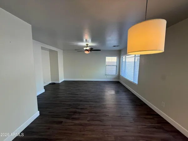 a view of a room with wooden floor and a window