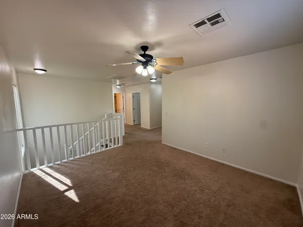 a view of a livingroom with a ceiling fan and window