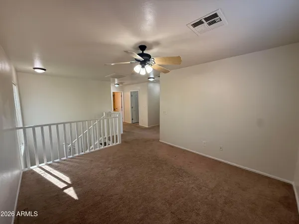 a view of a livingroom with a ceiling fan and window