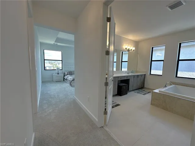 a spacious bedroom with a bed and a large window