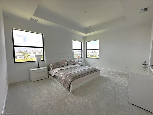 a spacious bedroom with a bed and a couch