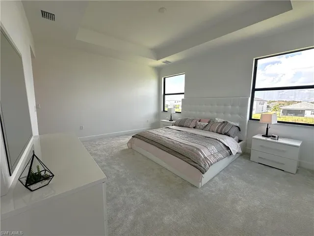 a bedroom with a bed and a tv