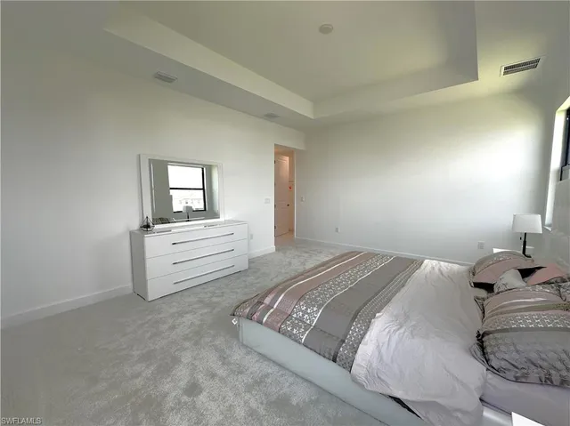 a en suite bathroom with a double vanity sink a large mirror and a bathtub