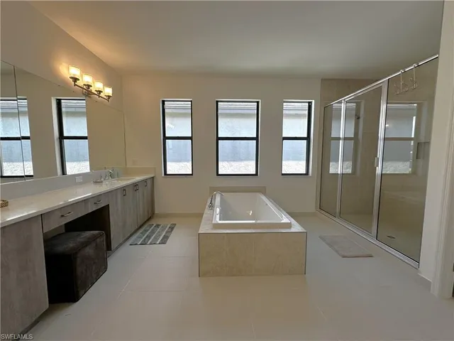 a view of living room kitchen with a stove top oven and sink