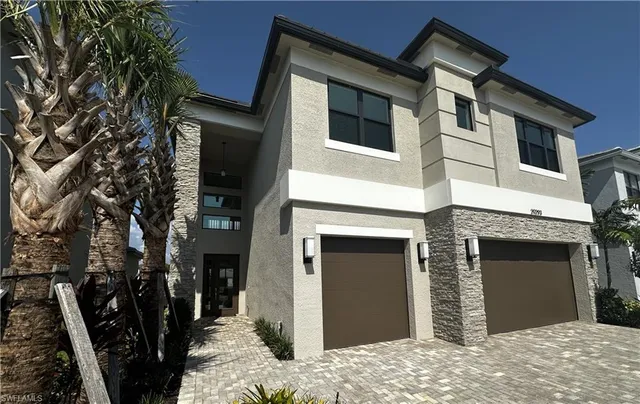a view of a house with a yard and garage