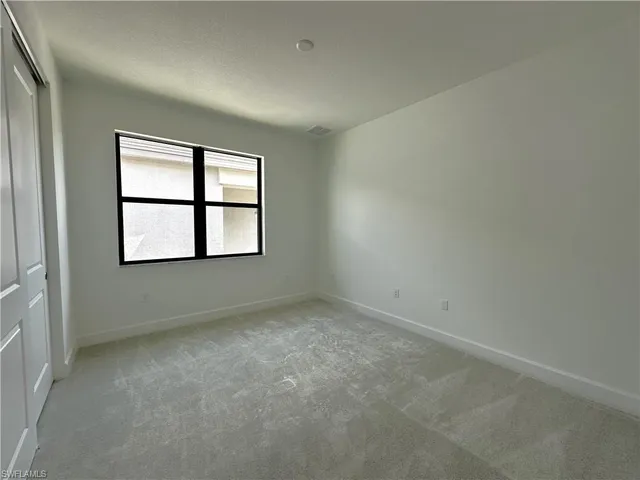 a spacious bedroom with two beds and a table