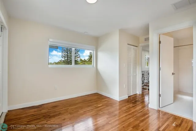 a view of a room with wooden floor and window