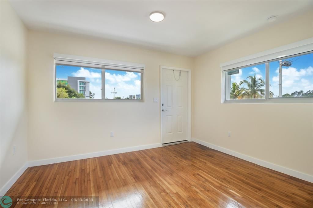 1001 Northeast 80th Street, Unit 4 Miami, FL 33138 - Photo 13 of 27 a view of empty room with wooden floor and fan