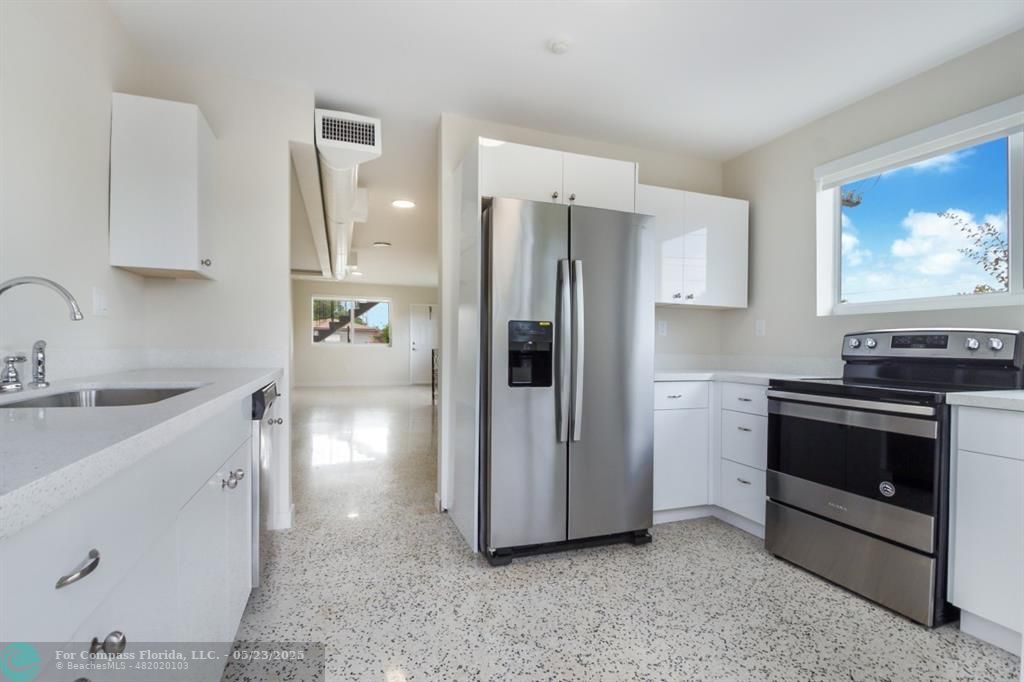 1001 Northeast 80th Street, Unit 4 Miami, FL 33138 - Photo 19 of 27 a kitchen with stainless steel appliances a refrigerator sink and stove