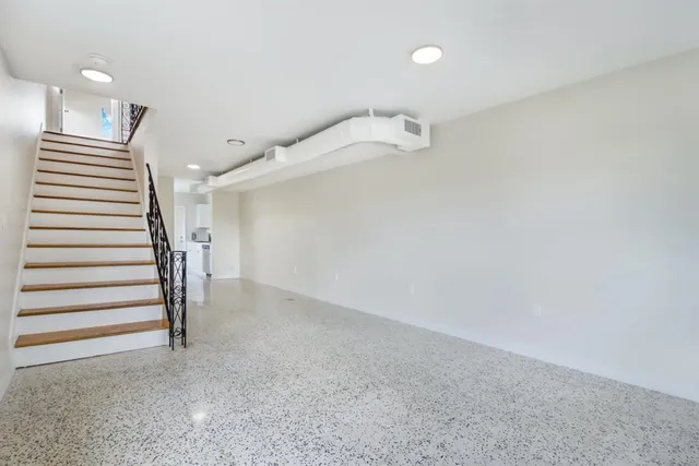 a view of a hallway with stairs