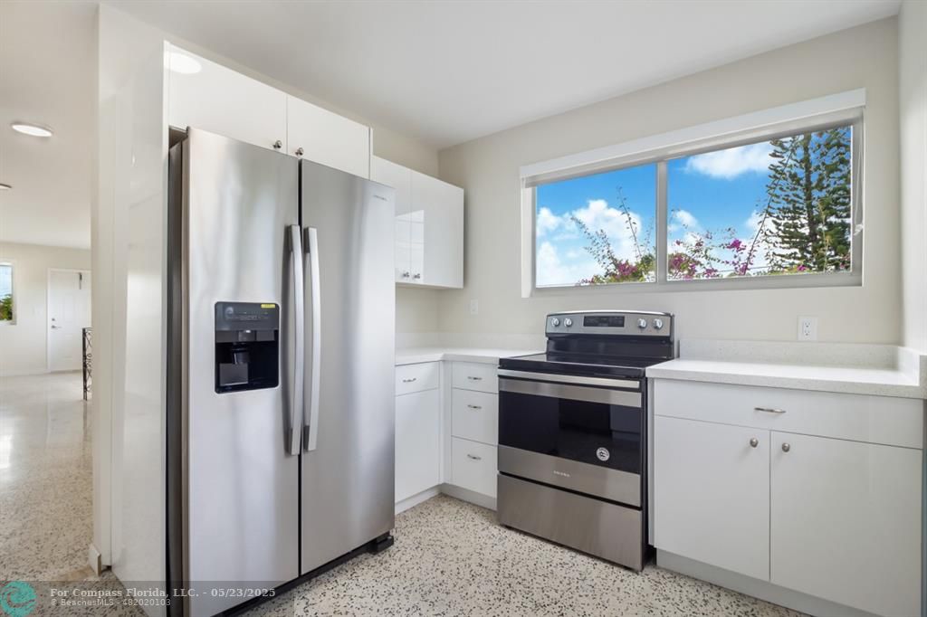 1001 Northeast 80th Street, Unit 4 Miami, FL 33138 - Photo 21 of 27 a kitchen with stainless steel appliances granite countertop a refrigerator stove and sink