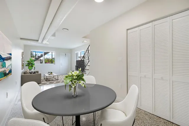 a dining room with furniture and wooden floor