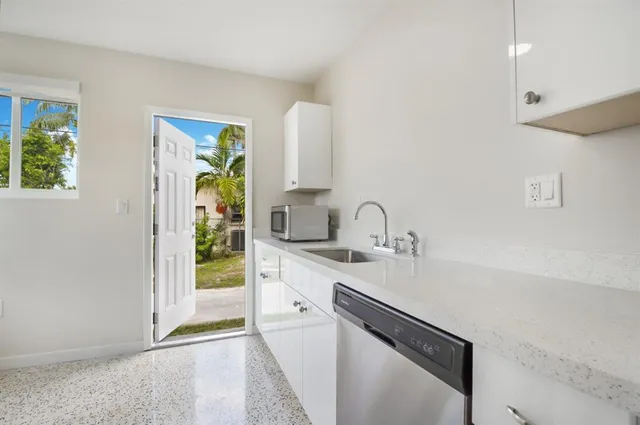 a kitchen with stainless steel appliances a sink stove and cabinets