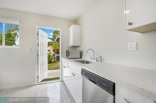 a kitchen with stainless steel appliances a sink stove and cabinets