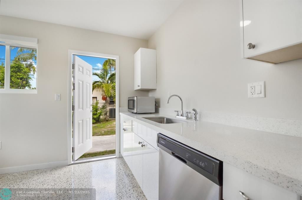1001 Northeast 80th Street, Unit 4 Miami, FL 33138 - Photo 5 of 27 a kitchen with stainless steel appliances a sink stove and cabinets