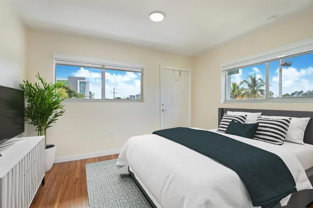 a bedroom with a large bed and a window